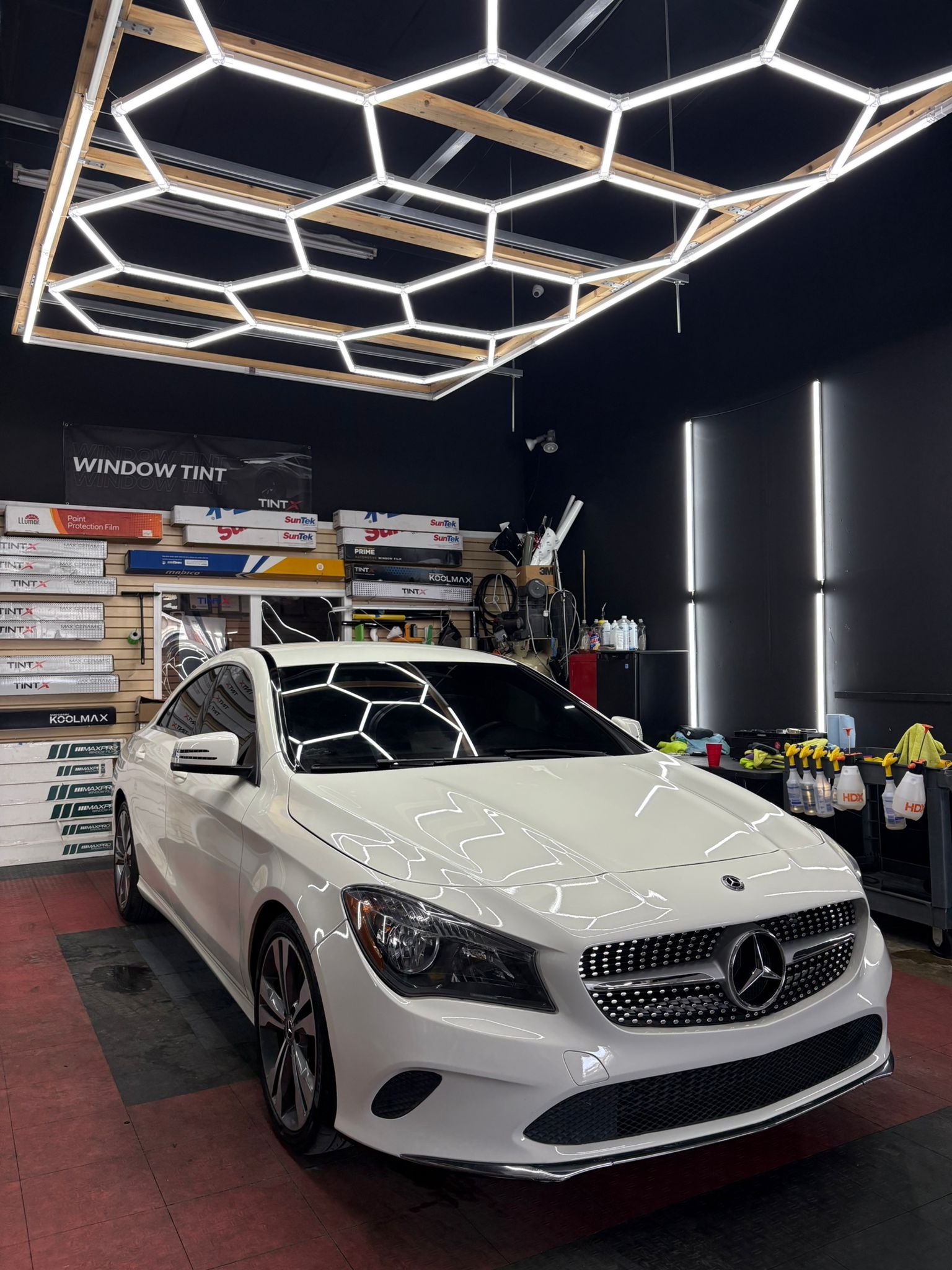 White Mercedes-Benz CLA receiving window tint installation.